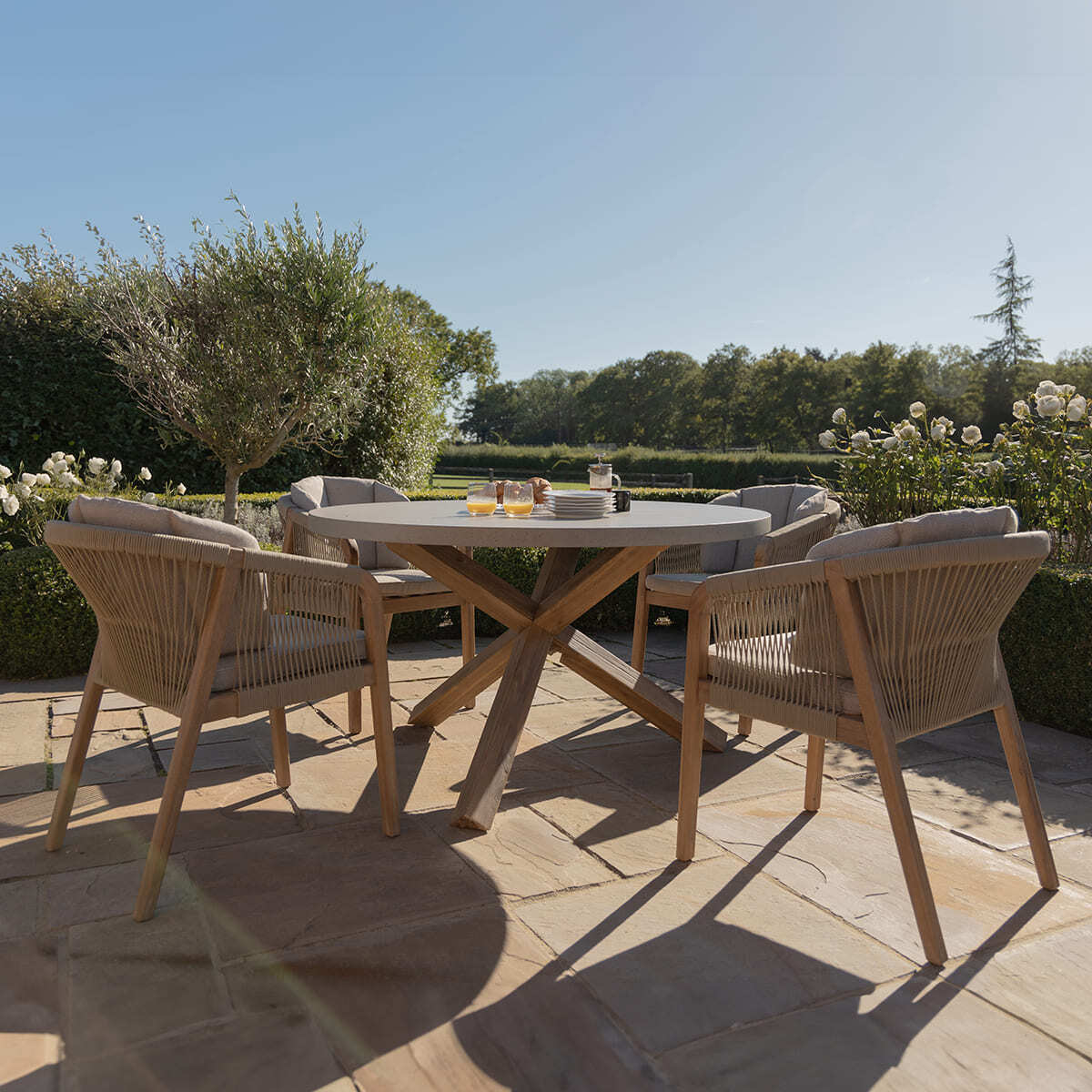 Martinique 4 Seat Round Dining Set with 135cm Concrete Table Top. GardenBox Price £1449