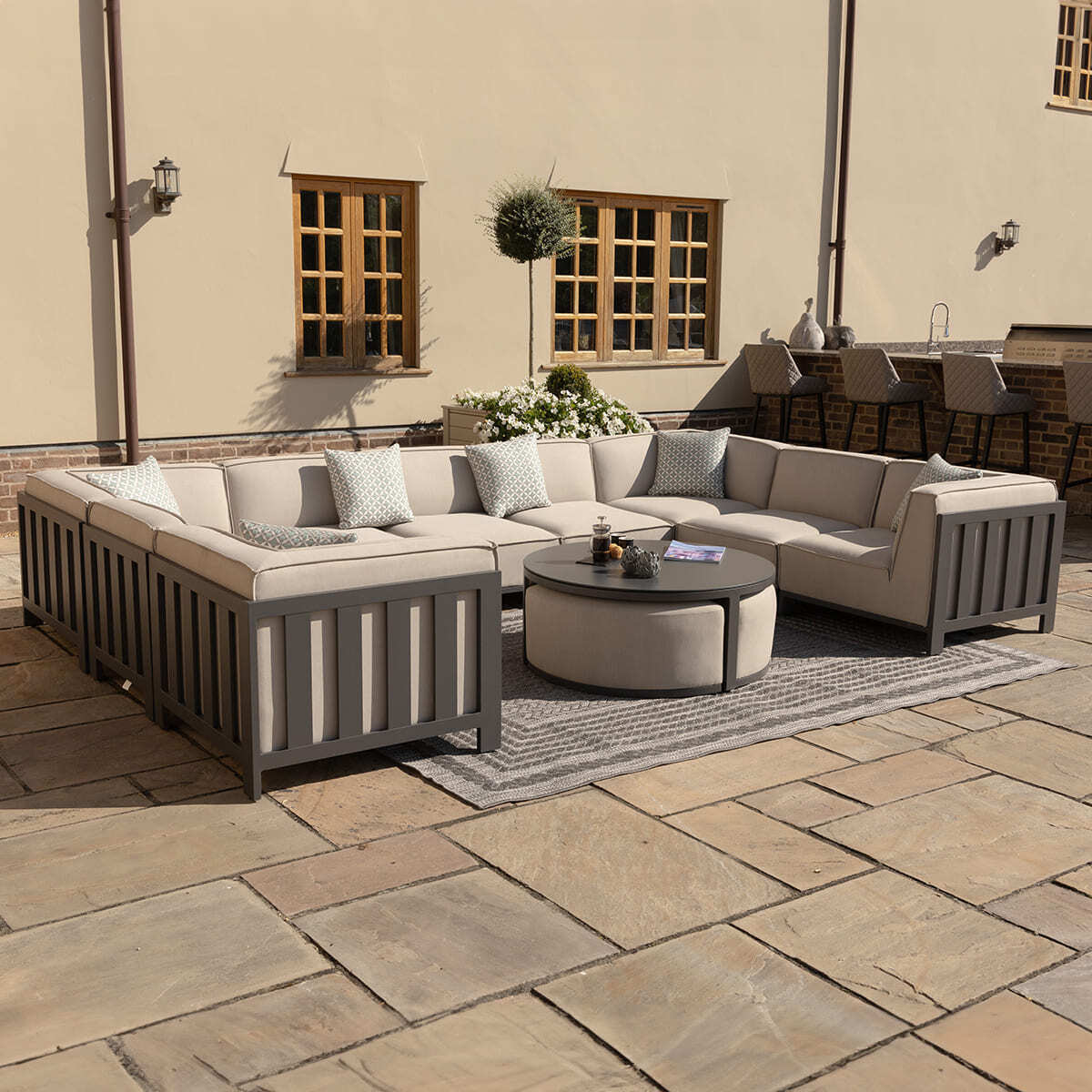 IBIZA U Shape Sofa Set with round coffee table with 3 foot stools by Maze Rattan. GardenBox Price £5499